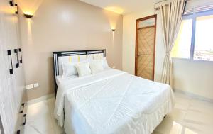 a bedroom with a white bed and a window at Nuellas Haven in Kira +25 photos