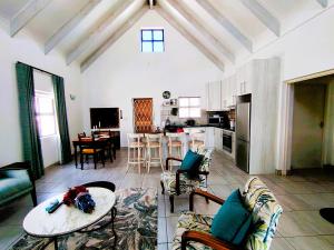a living room with a couch and a table at Mosseltjie - Self Catering in Britannia Bay