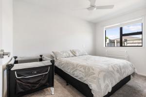 a bedroom with a bed and a window at Peaceful Paradise - Waihi Beach Holiday Home in Waihi Beach