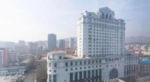 um grande edifício branco no meio de uma cidade em Jinjiang Inn Weihai Liugong Island Scenic Spot Shopping Market em Weihai