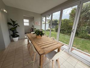 a dining room with a wooden table and chairs at The Tidal Court in Sea Vista