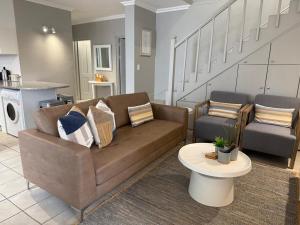 a living room with a couch and a table at The Tidal Court in Sea Vista