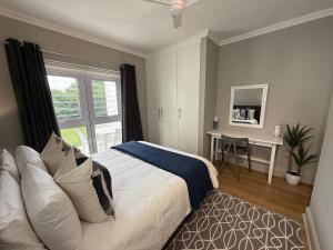 a bedroom with a bed and a window and a desk at The Tidal Court in Sea Vista +45 photos