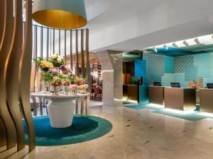 a lobby with a table with flowers on it at Novotel Istanbul Bosphorus Hotel in Istanbul