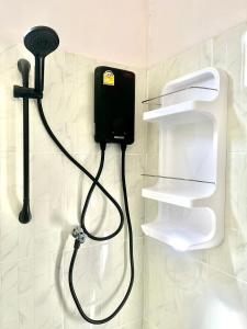 a bathroom with a soap dispenser on a wall at Yada House s&s in Nai Yang Beach