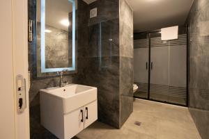 ein Badezimmer mit einem weißen Waschbecken und einem Spiegel in der Unterkunft Navoris Hotel in Istanbul