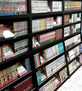 a shelf filled with lots of books at Business Hotel Legato in Tokyo