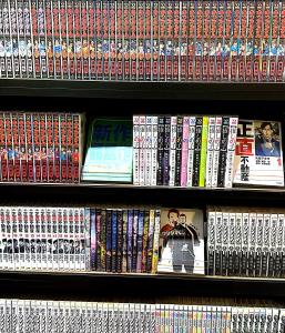a shelf full of video games and books at Business Hotel Legato in Tokyo +15 photos