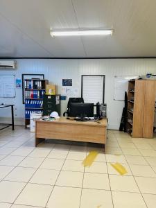 an office with a desk with a computer on it at Private Room behind Out of Africa in Otjiwarongo +1 photo