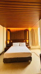 The Golden Tree Hotels Jaunpur في Jaunpur: غرفة نوم بها سرير كبير في الغرفة