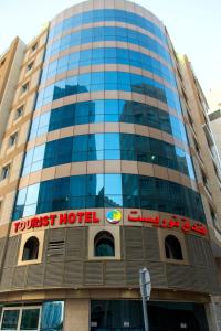 un edificio alto con un cartel de hotel turístico en Tourist Hotel, en Doha