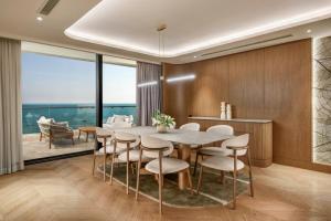a dining room with a table and chairs at Regnum The Crown in Belek