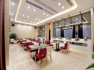 a dining room with tables and red chairs at Lavande Hotel Guangzhou Zengchen Xintang Light Railway Station in Zhongtang