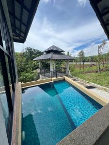 a swimming pool in a house with a gazebo at Bungalow Pool Villa in Port Dickson