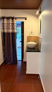 a bathroom with a sink and a counter with a mirror at Wildcrest Homestay in Madikeri +38 photos