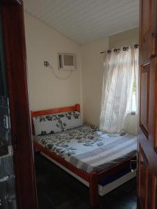 Ένα ή περισσότερα κρεβάτια σε δωμάτιο στο Pousada Descanse & Curta