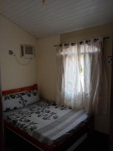 Ένα ή περισσότερα κρεβάτια σε δωμάτιο στο Pousada Descanse & Curta