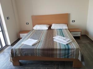 a bedroom with a bed with two towels on it at Vila Tatjana in Vuno