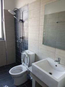 a bathroom with a white toilet and a sink at Vila Tatjana in Vuno