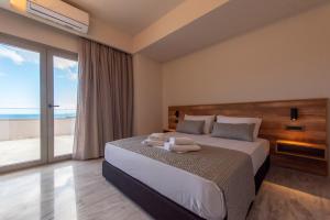 a bedroom with a bed with a view of the beach at Villa Dorothea in Georgioupoli +55 photos