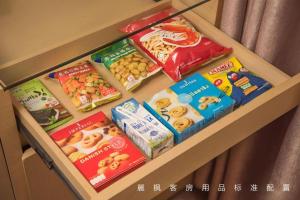 a drawer filled with different kinds of snacks on a shelf at Lavande Hotels Suzhou Railway Station in Suzhou