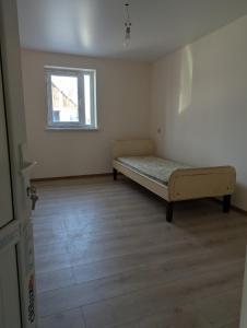 a bedroom with a bed in the corner of a room at Cozy Home - separate private room in Verin Ptghni