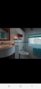 a bathroom with a sink and a toilet and a tub at Finca Sencilla in Mijas