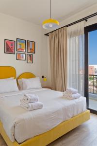 a bedroom with a bed with towels on it at VESTA - El Gouna Residence in Hurghada
