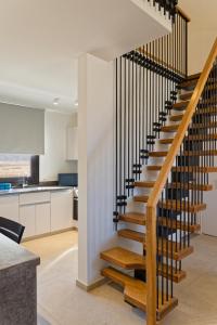 a staircase in a kitchen with white walls at VESTA - El Gouna Residence in Hurghada +4 photos