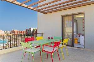 a patio with a table and chairs on a balcony at VESTA - El Gouna Residence in Hurghada