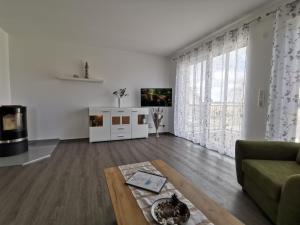 a living room with a couch and a coffee table at Ferienwohnung in Zingst Müggenburg, hochwertig und ruhig urlauben in Müggenburg