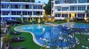 a large swimming pool in front of a building at Karon Butterfly Phuket in Ban Karon