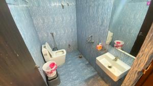 a bathroom with a sink and a toilet and a mirror at Soni's Mansion-100m from Khajuraho Temples in Khajurāho +53 photos