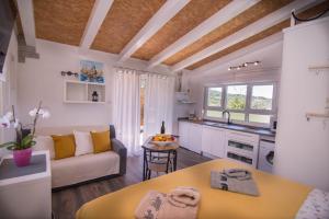 a kitchen and living room with a couch and a table at Andrej studio A2 in Veli Lošinj