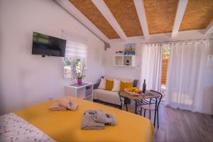 a bedroom with two beds and a living room at Andrej studio A2 in Veli Lošinj