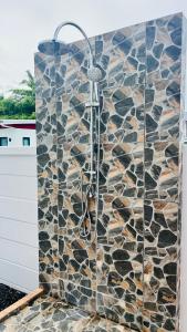 a bathroom with a shower in a stone wall at Pooky Pool Villa Aonang in Ban Nong Chaeng