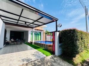 an outdoor patio with a pool and a house at Pooky Pool Villa Aonang in Ban Nong Chaeng