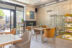 a restaurant with tables and chairs and a sign on the wall at River Side Residence 3/18 in Oświęcim