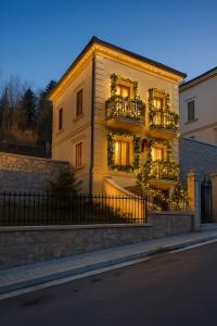 a building with plants on the balconies on it at NN Villa in Korçë