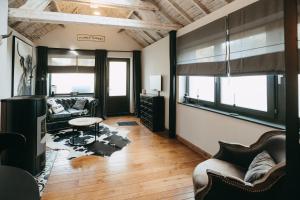 a living room with a couch and a table at L'Al-Golette by Curtis in Mellet