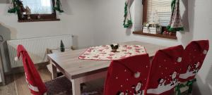 a dining room table and chairs with christmas decorations at Wellness Chata Tatry in Veľká Lomnica +56 photos