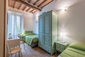 Ένα ή περισσότερα κρεβάτια σε δωμάτιο στο Podere La Miniera Room And Food