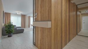 a living room with a wooden wall at Le Luna Apart in Braşov