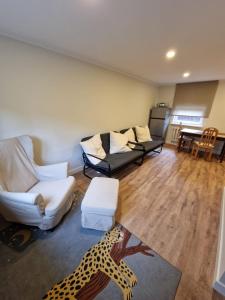 a living room with two couches and a leopard rug at Brīvdienu māja Vecdaugavā in Rīga