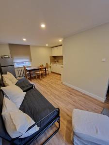 a living room with two beds and a table at Brīvdienu māja Vecdaugavā in Rīga