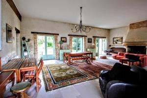 a living room with a table and a fireplace at Gîte Gué Léger - Nature & Spa - Jacuzzi, Sauna - Piscine chauffée toute l'année - 15 pers in Chanceaux-près-Loches
