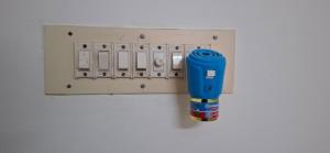 a blue gas lighter next to an electrical panel at Ashwin Home Stay in Tiruvannāmalai