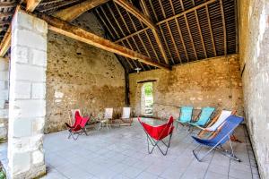 a group of chairs sitting on a patio at Gîte Gué Léger - Nature & Spa - Jacuzzi, Sauna - Piscine chauffée toute l'année - 15 pers in Chanceaux-près-Loches