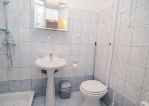 a white bathroom with a toilet and a sink at Andjelka B4-Blue in Mali Lošinj +30 photos
