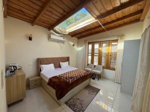 a bedroom with a bed and a large window at Shail by Shubhs in Bhowāli